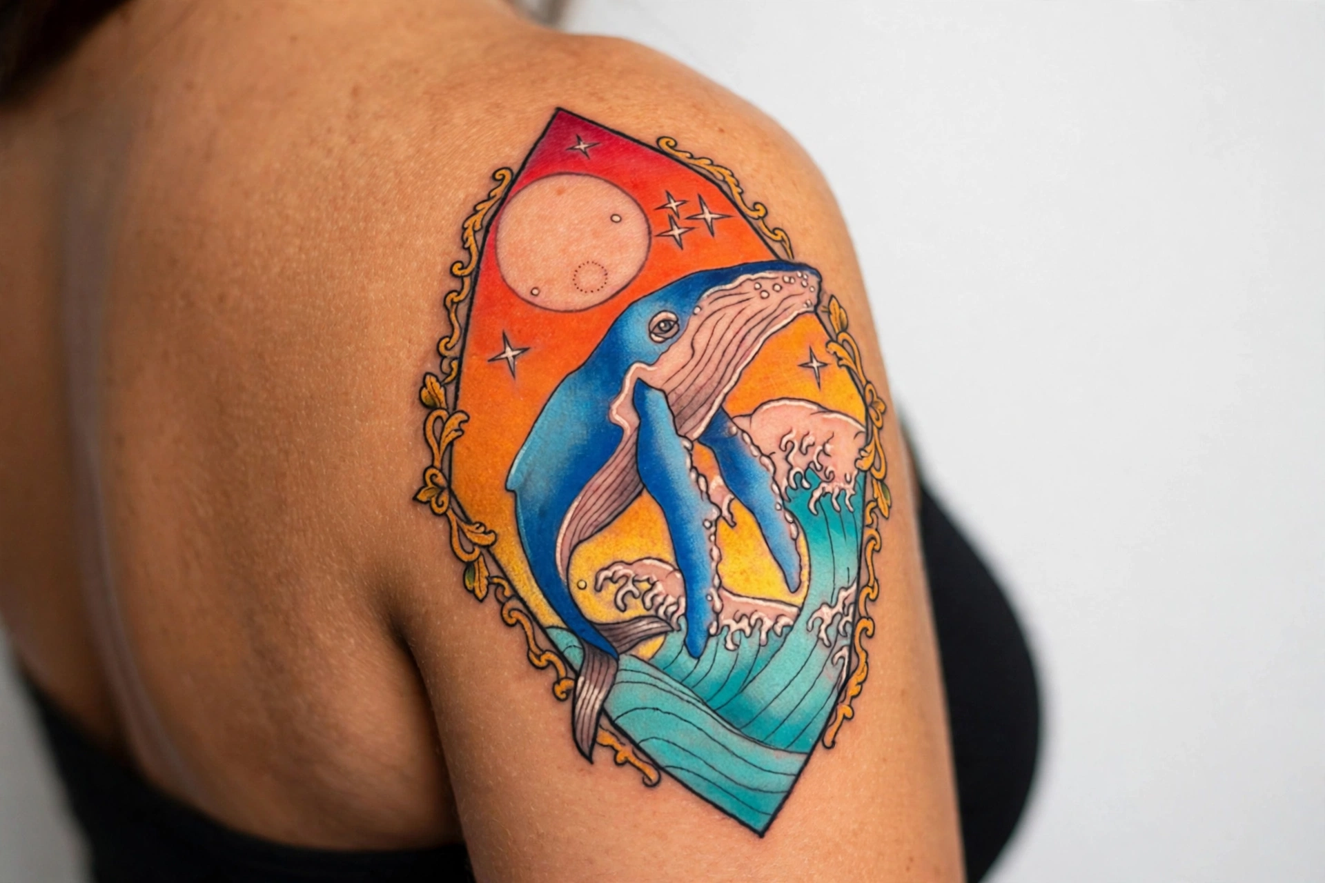 Humpback whale breaching with water spray tattoo