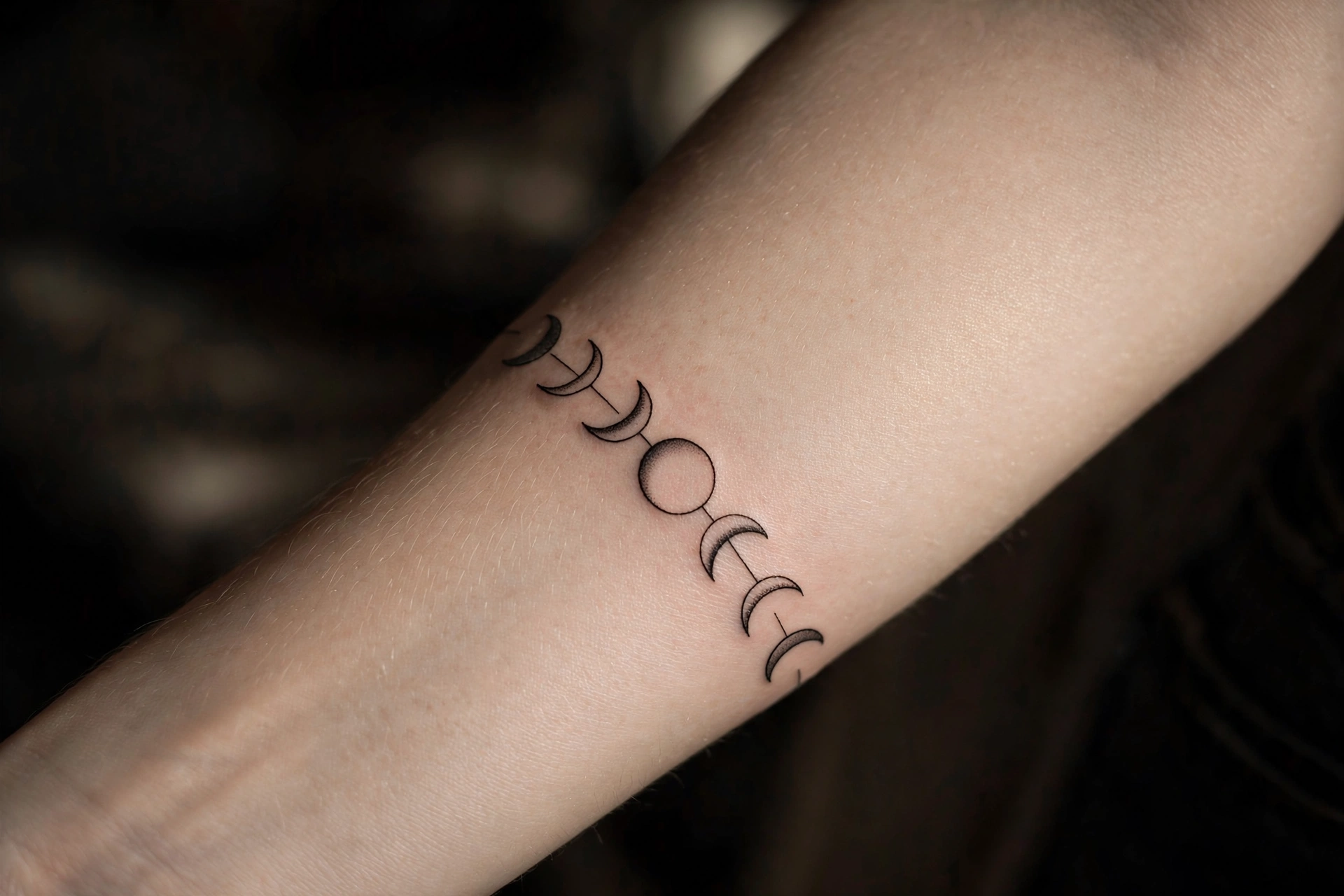 Scattered tiny star tattoos across a woman's arm