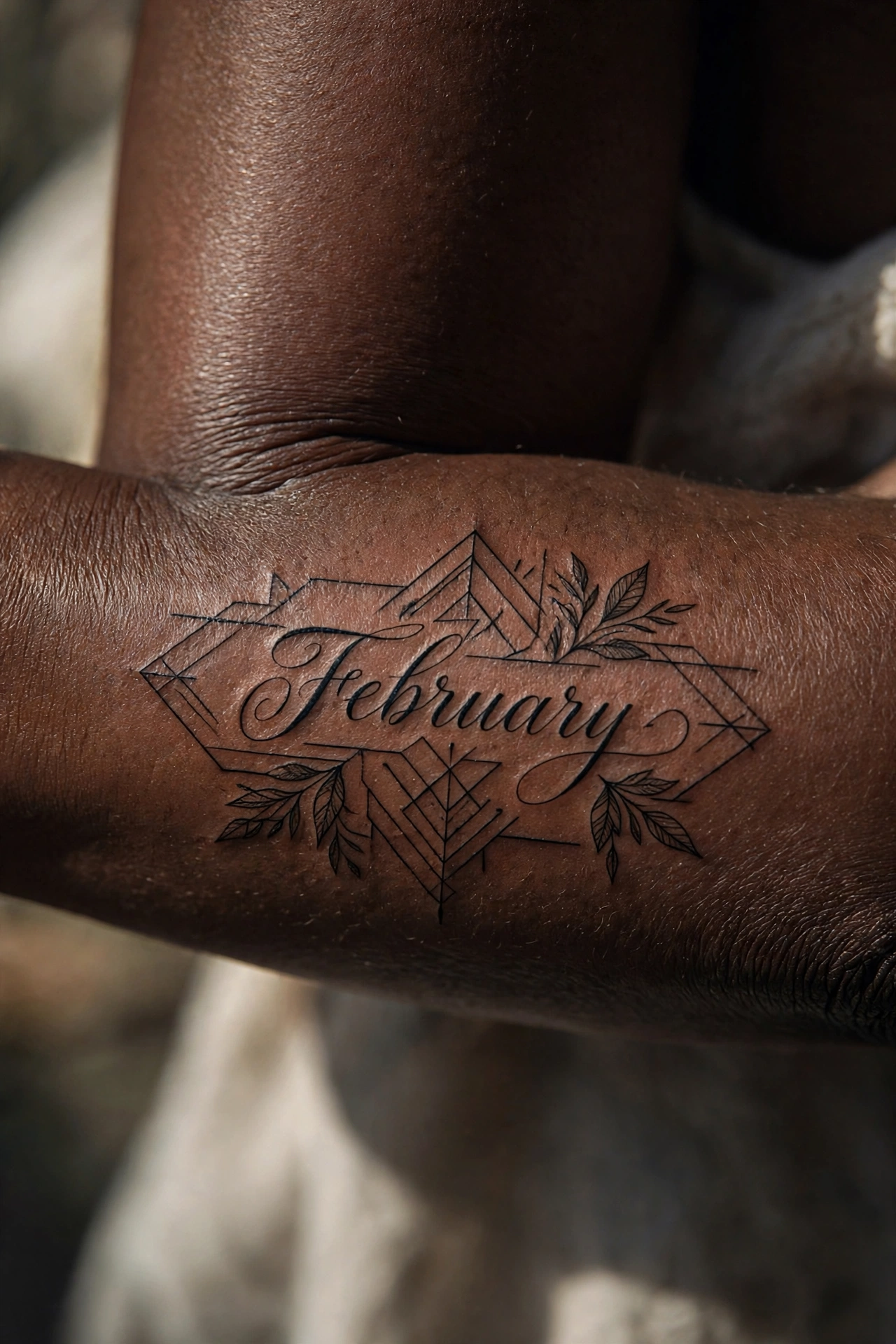 February written in flowing calligraphy tattoo