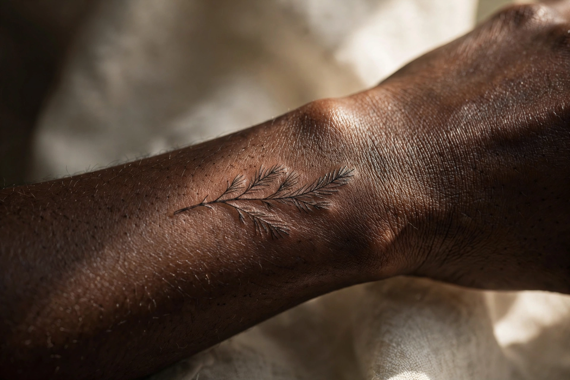 Simple evergreen branch tattoo with snow
