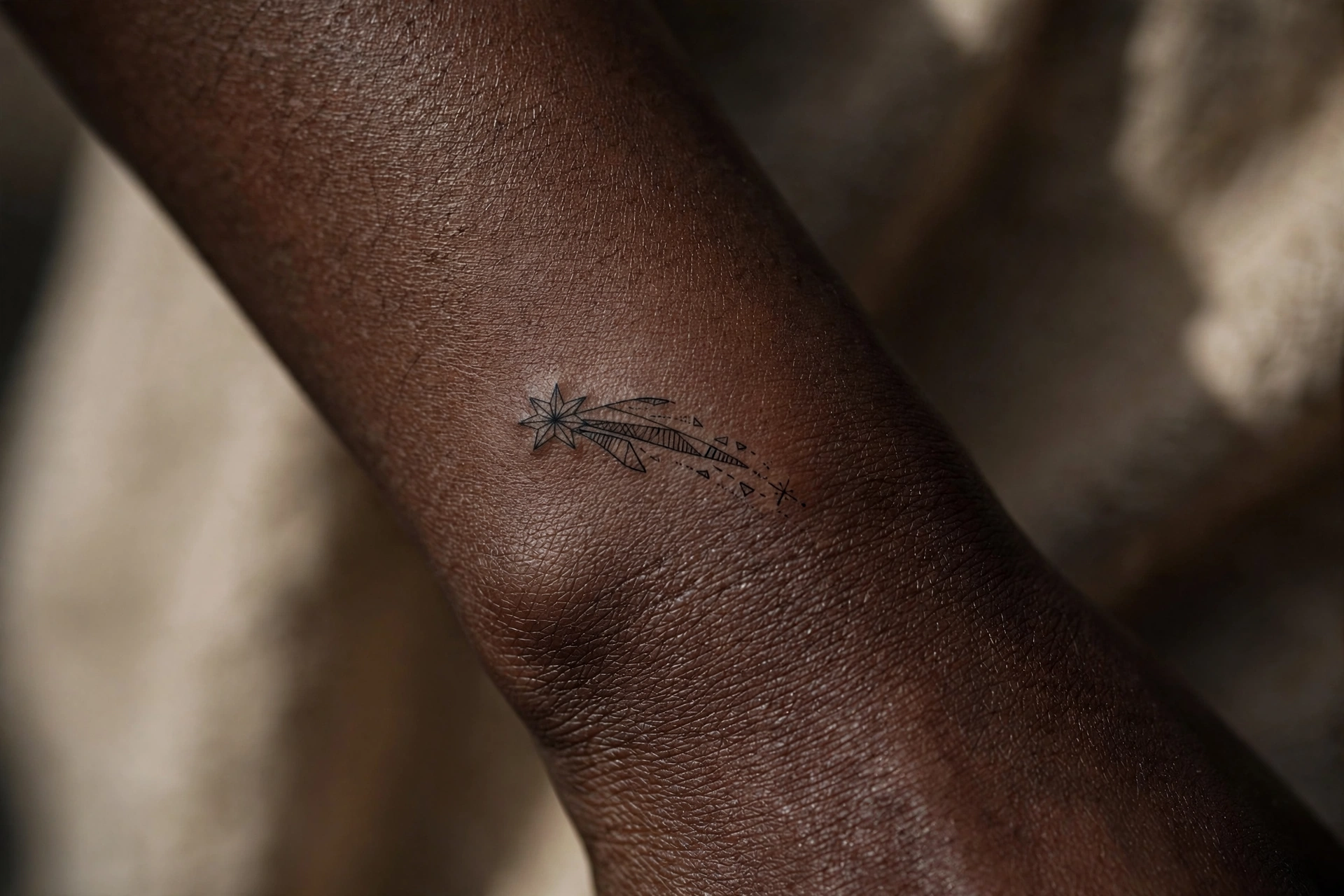 Tiny shooting star first tattoo idea for women on the shoulder