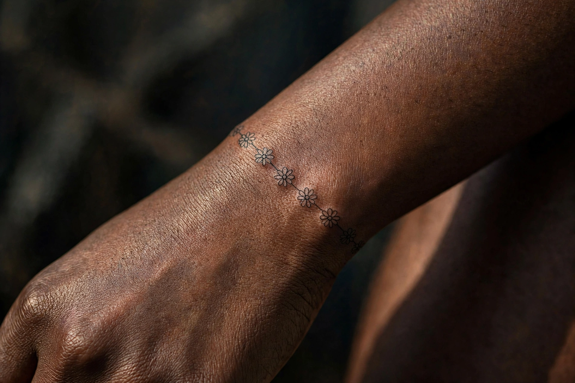 Tiny daisy chain first tattoo idea for women on the ankle