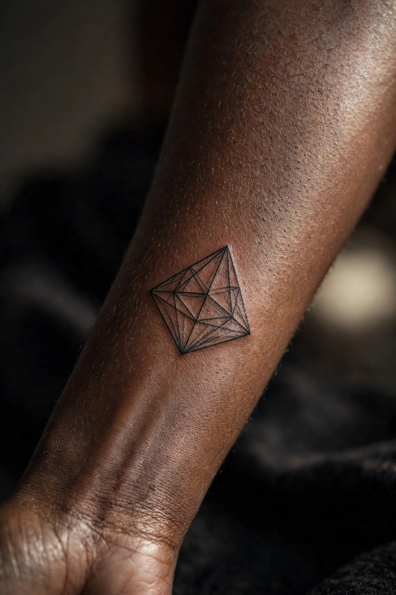 Tetrahedron geometric tattoo on man's wrist