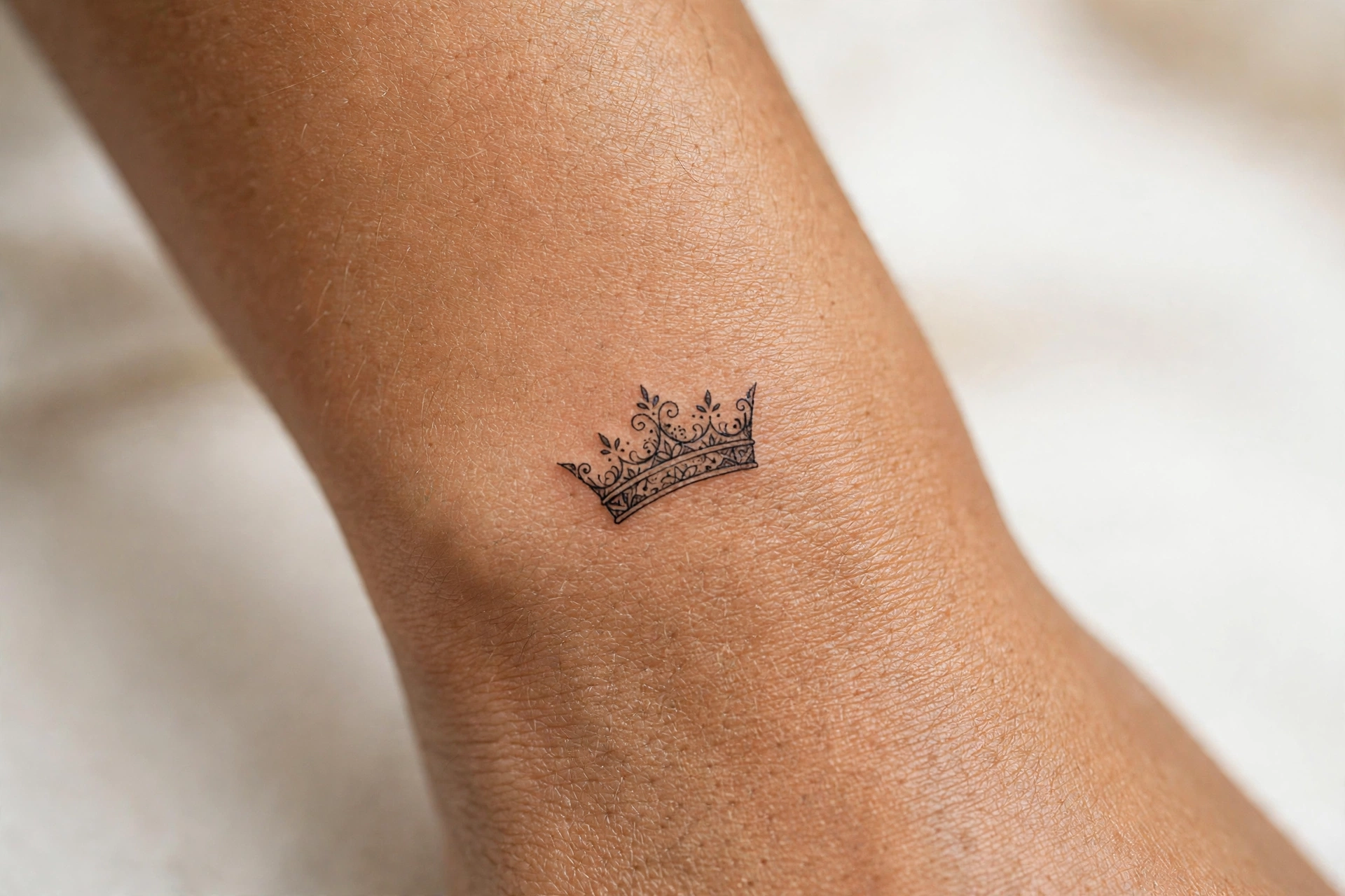 Tiny crown girly tattoo idea on the finger
