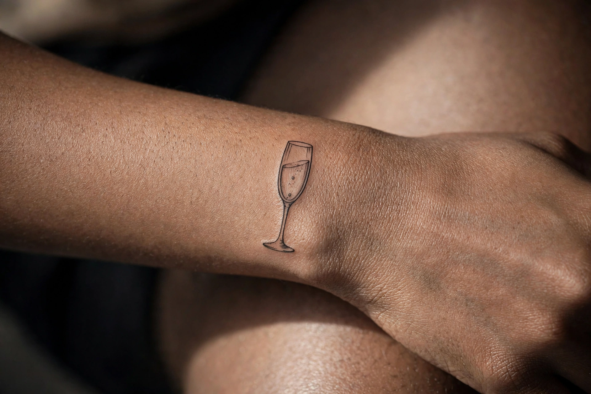 Champagne glass girly tattoo idea on the ankle