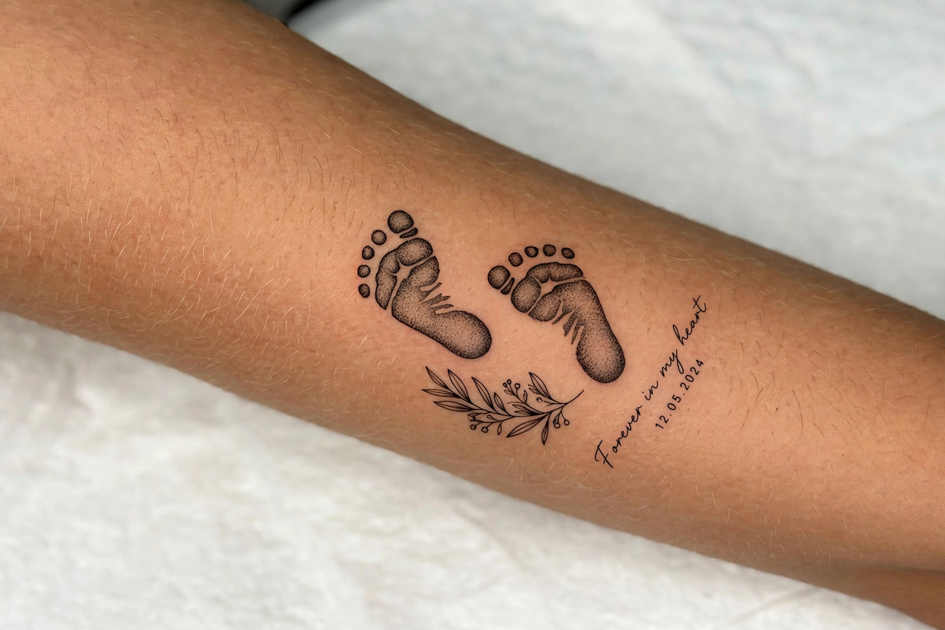 Baby footprint memorial tattoo with name and date