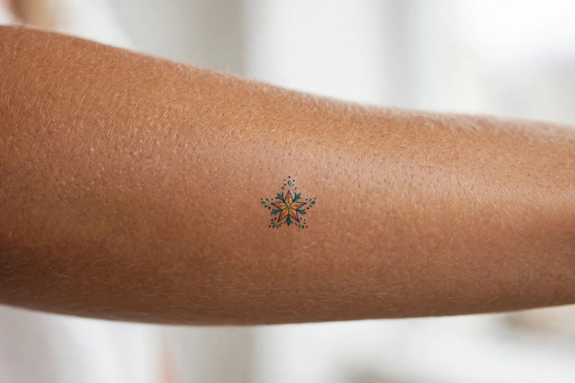 Single needle tiny star tattoo behind man's ear