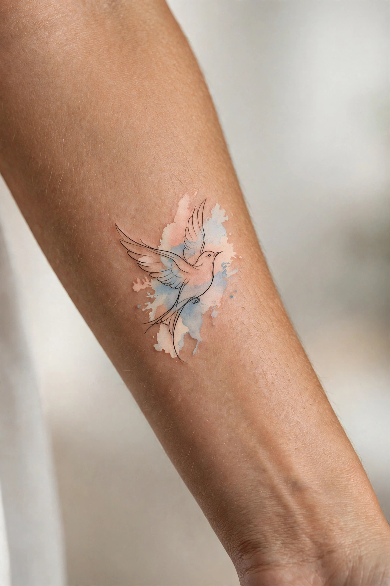 Line art bird in flight minimalist tattoo on man's collarbone