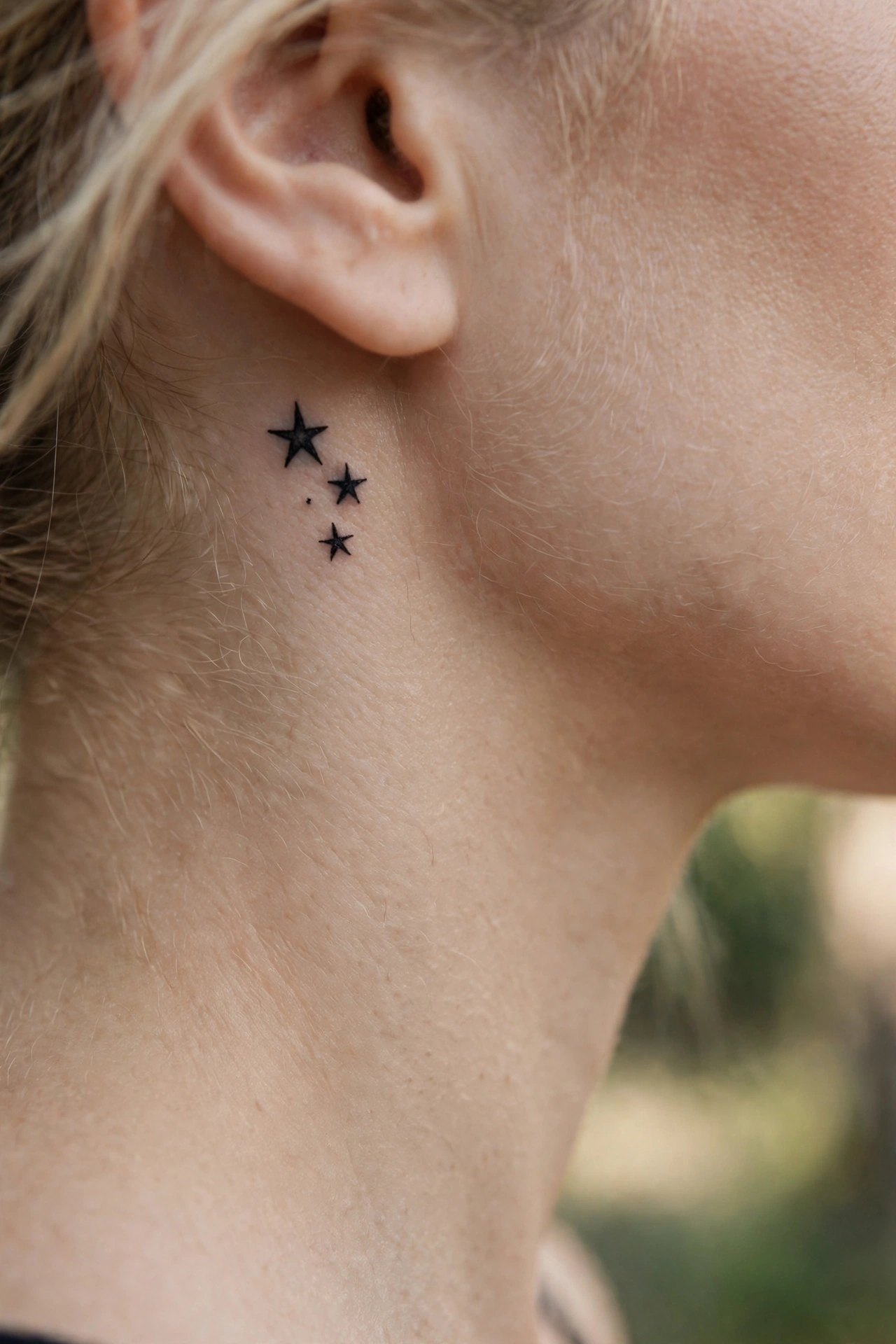 Ornamental lotus tattoo centered on a woman's throat