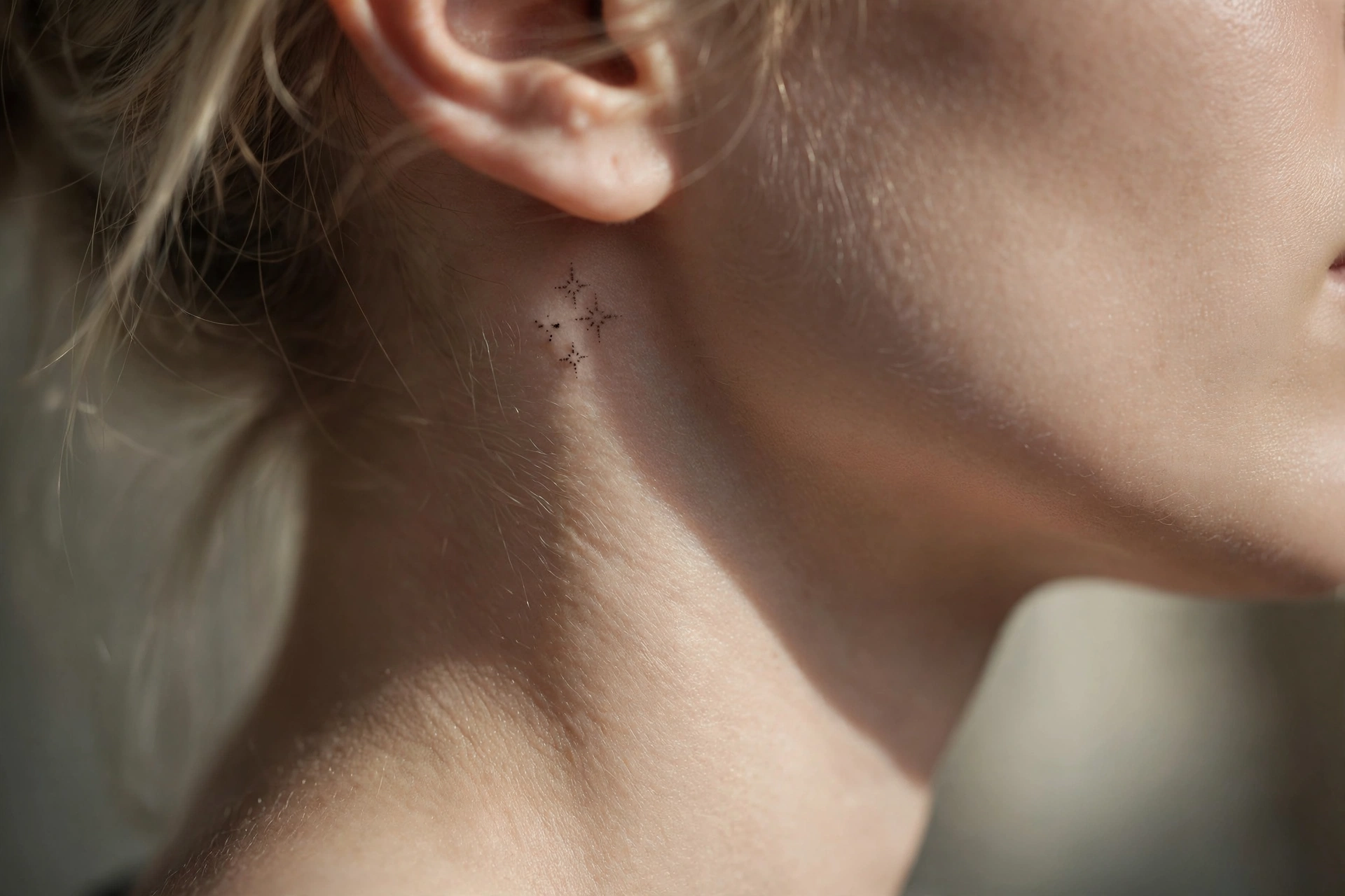 Tiny mountain range tattoo along a woman's side neck