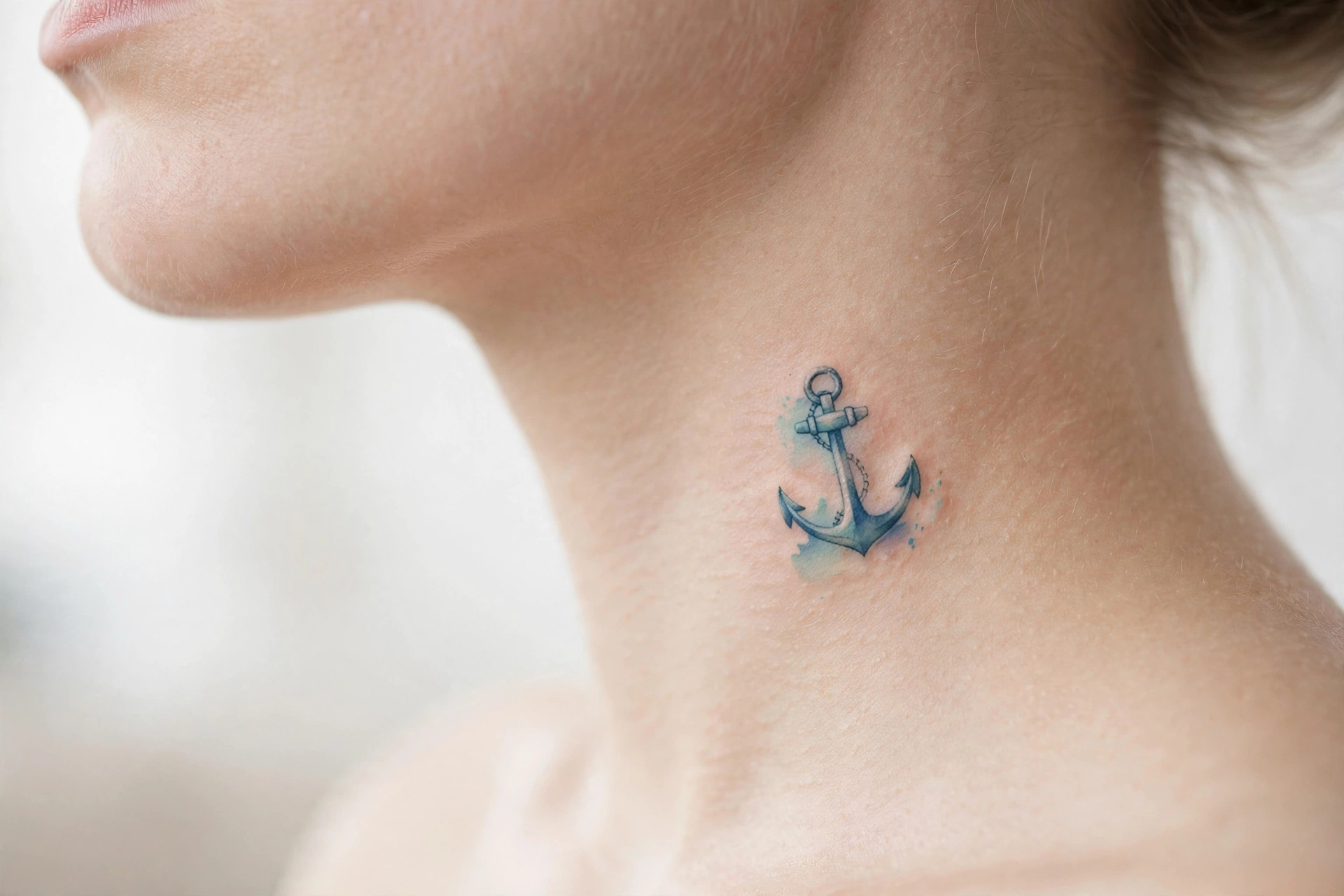Small anchor tattoo on the side of a neck