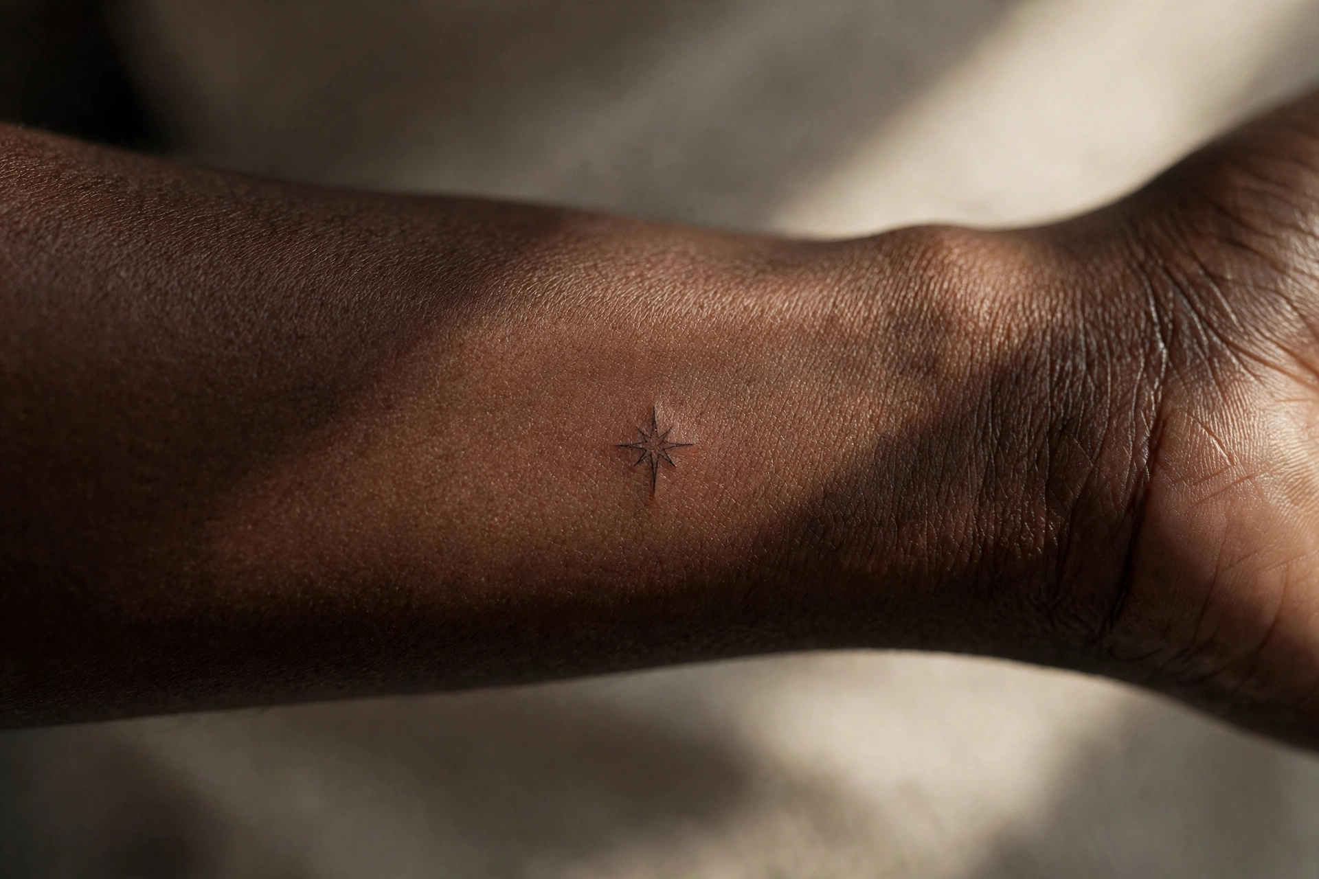 Tiny star tattoo behind man's ear