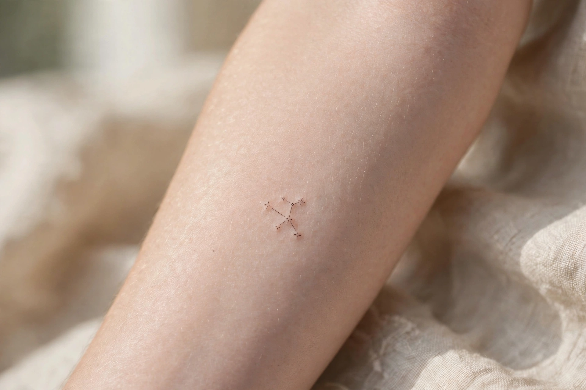 Small constellation tattoo on man's shoulder blade