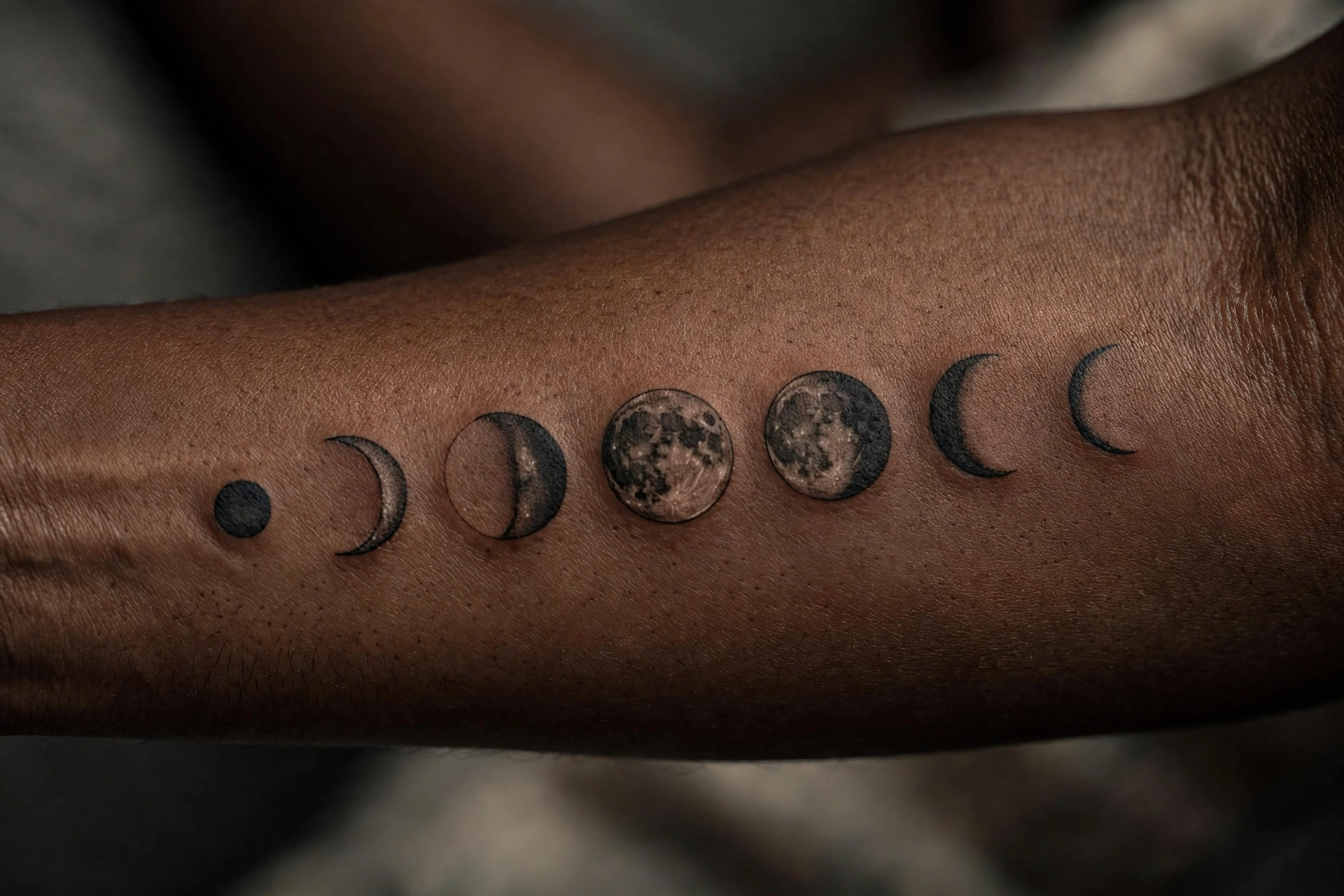 Crescent moon phases symbolic tattoo arc across the spine in fine line