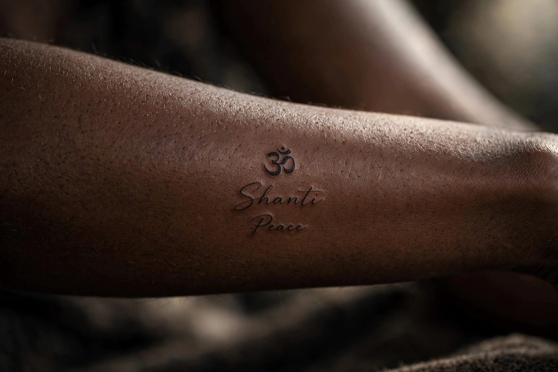 Om shanti peace script symbolic tattoo idea in elegant lettering on the ribcage