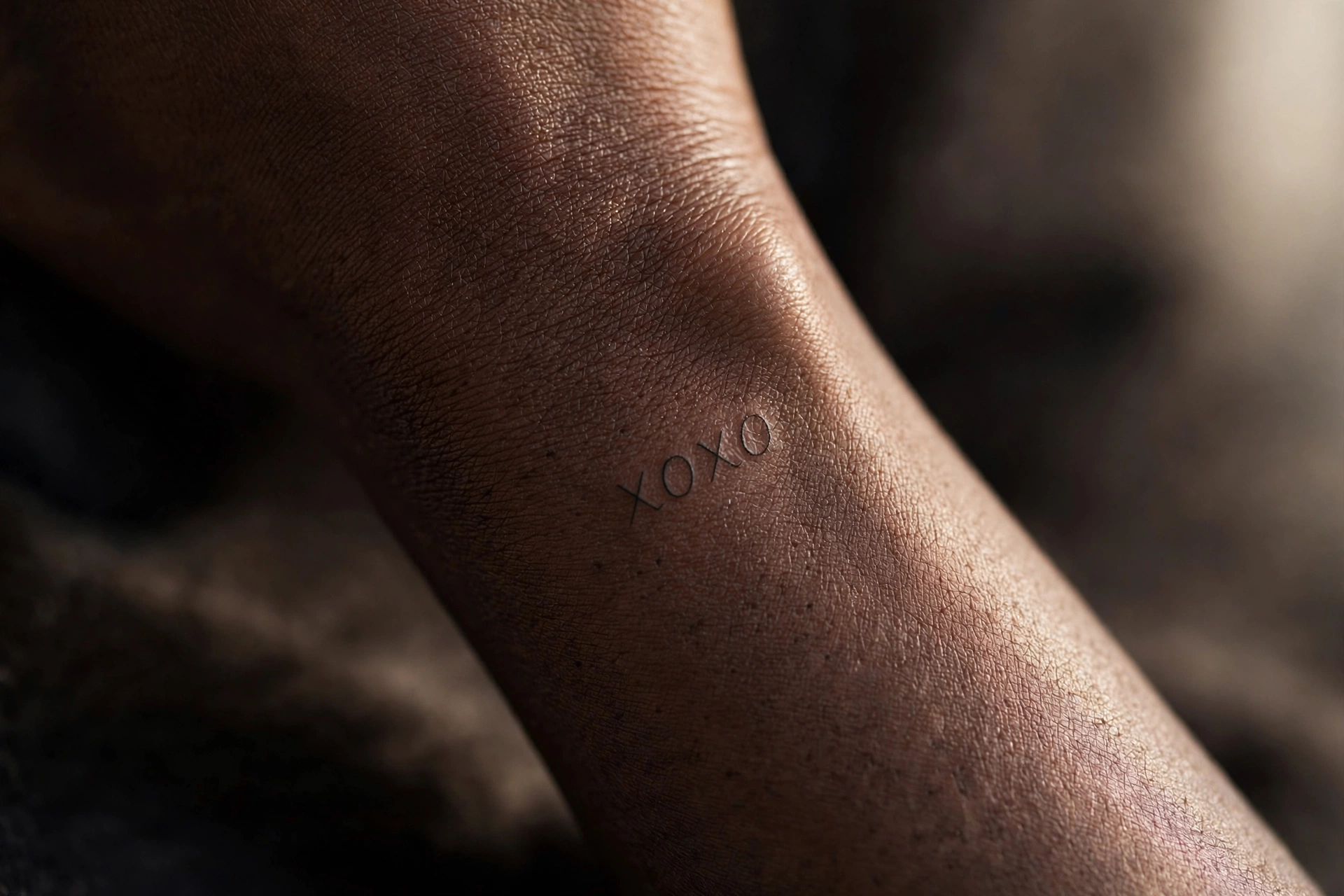 XOXO hugs and kisses lettering tattoo on ankle