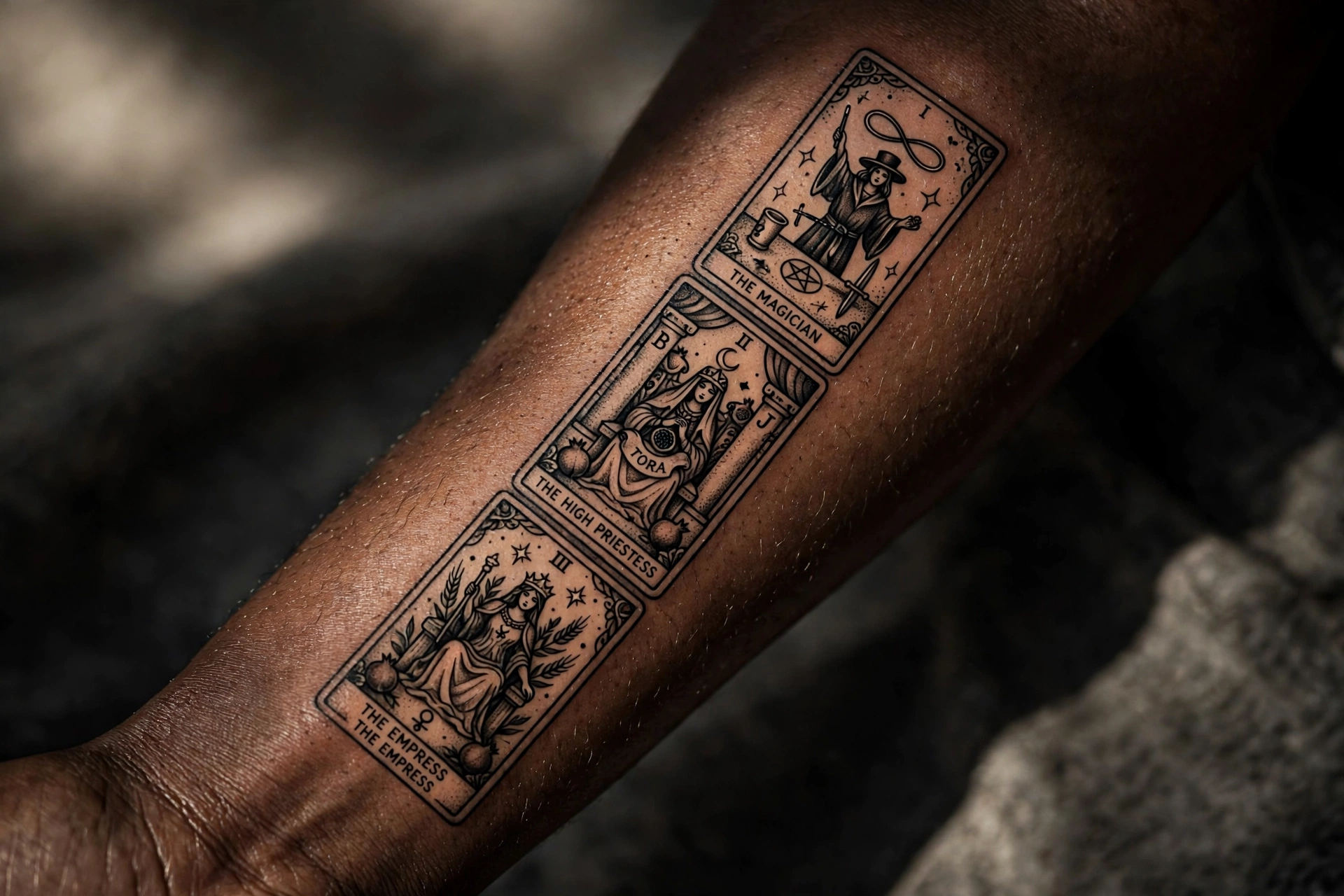 Three tarot card tattoos fanned out across a woman's thigh