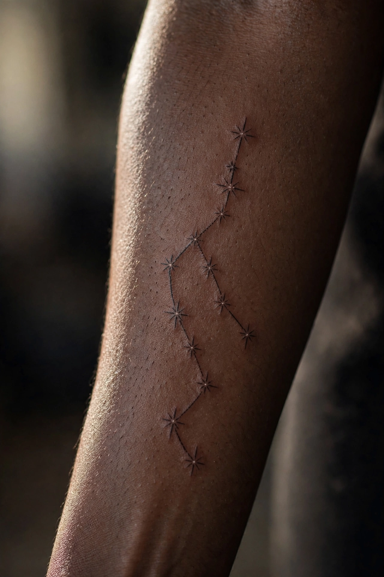 Dotwork star constellation tattoo trailing across a woman's collarbone